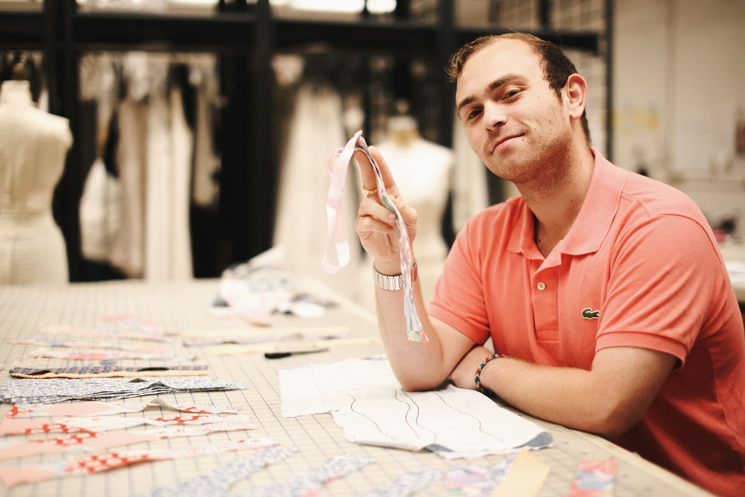 Portrait of a young queer fashion designer in a journalistic editorial setting. His bold yet refined style reflects innovation and self-expression, while dramatic lighting and thoughtful composition emphasize his artistic vision and individuality.