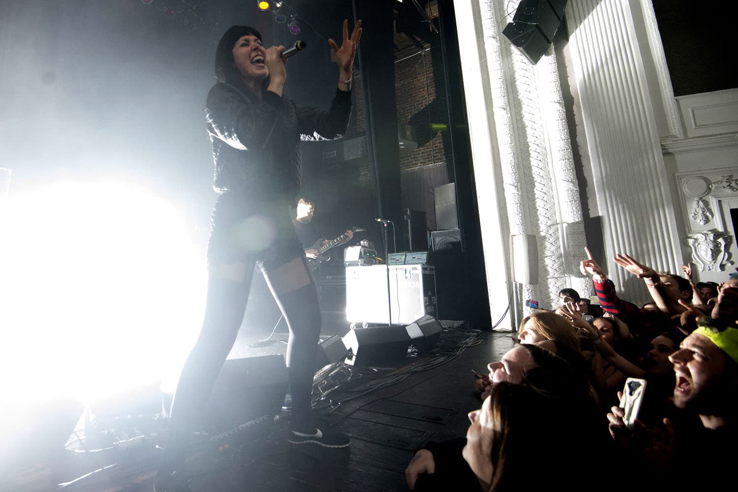 Festival concert photography of Alexis Krauss from Sleigh Bells performing. Noise pop and electronic rock performance with high-energy stage presence and complex lighting expertly documented.