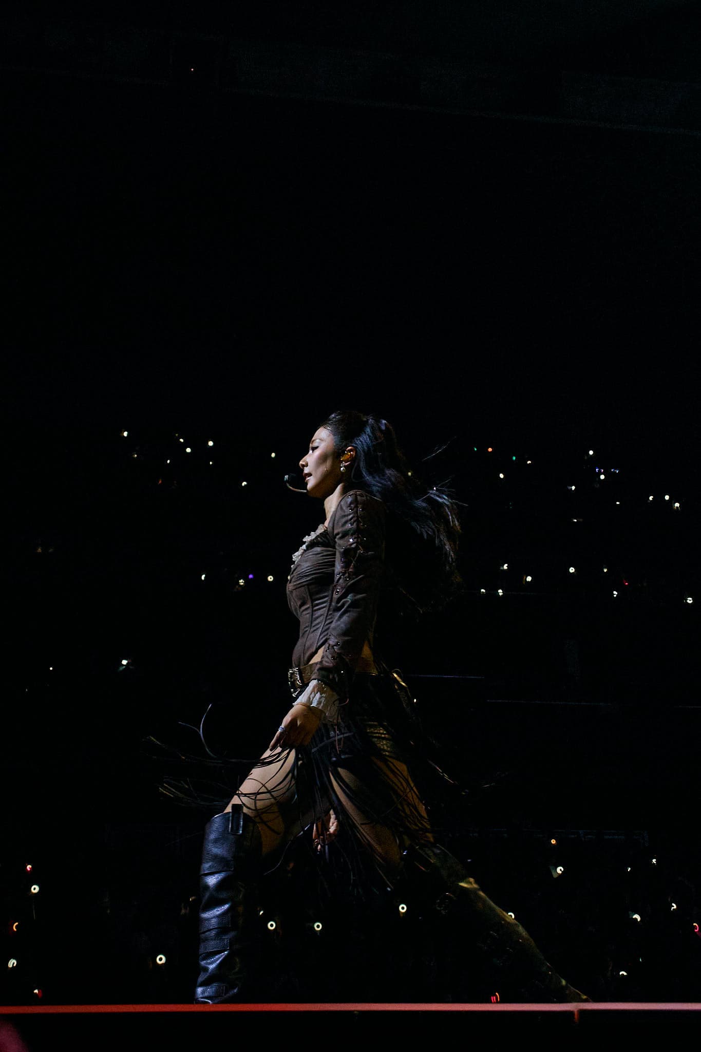 Concert photography of K-pop supergroup TWICE performing at the This Is For World Tour. Large-scale music arena performance with synchronized group choreography and professional stage production documentation.