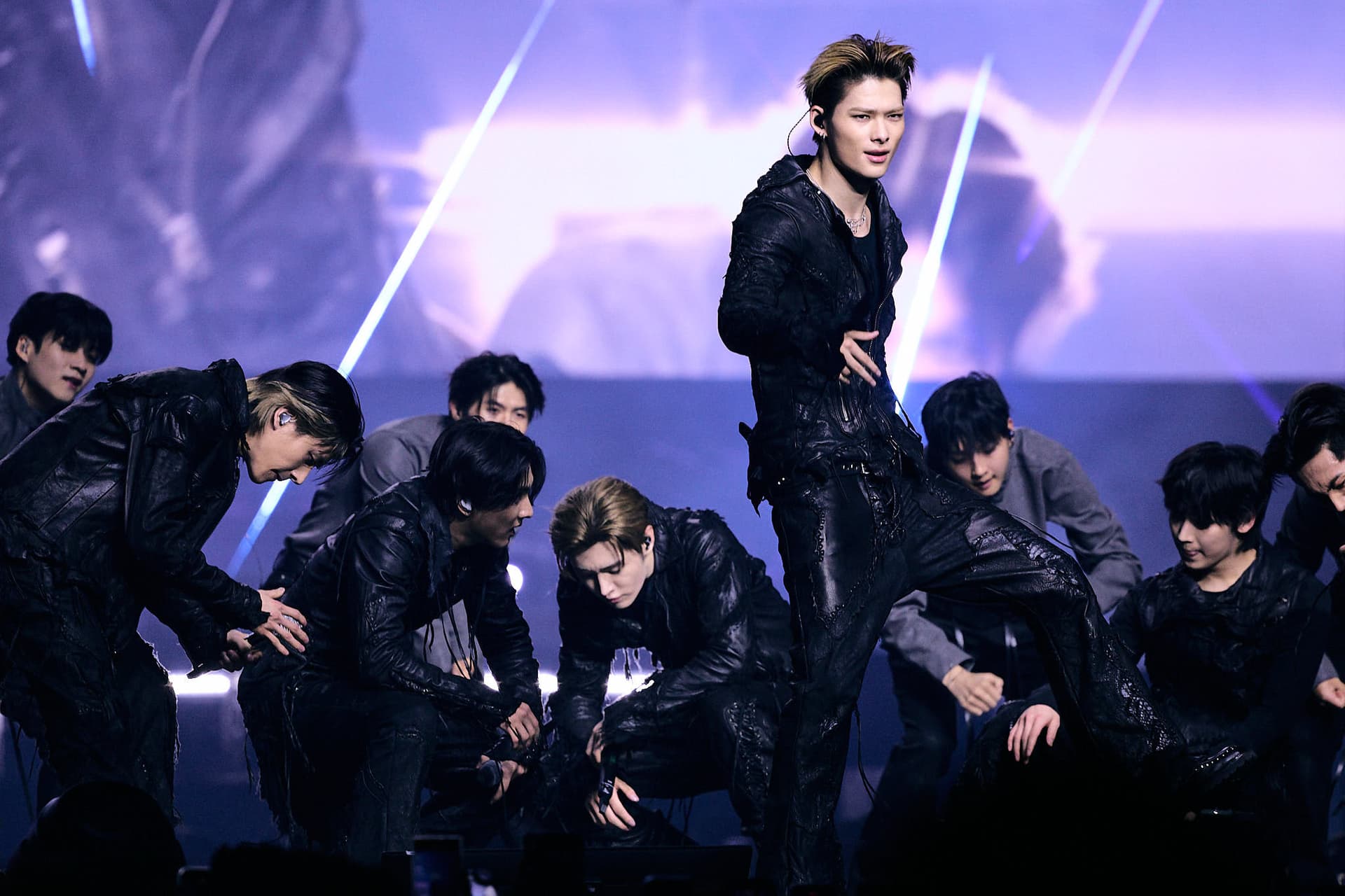 Concert photography of ENHYPEN performing on stage. Large venue K-pop group performance captured with professional stage lighting and dynamic crowd energy documentation.