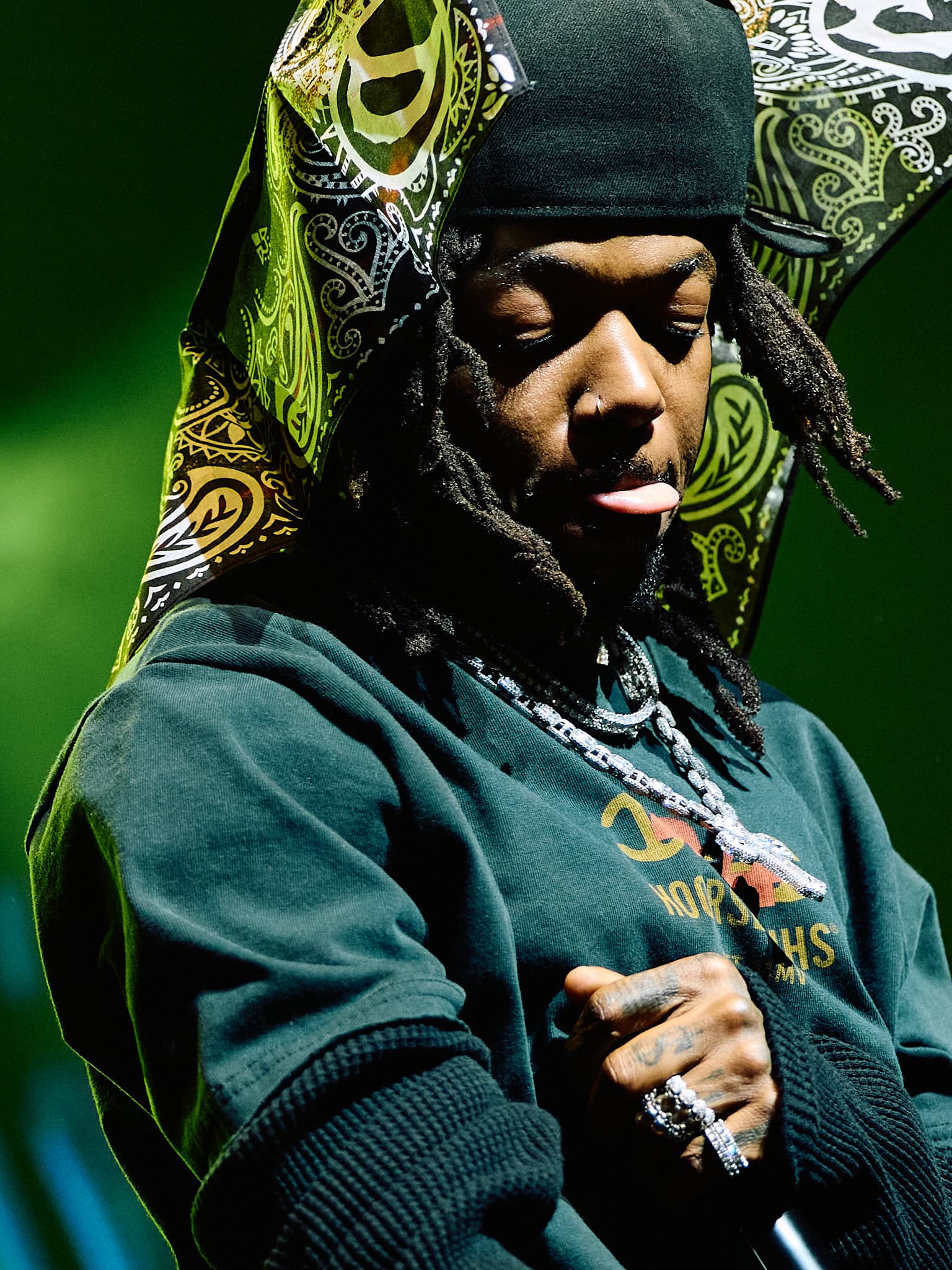 Concert photography of singer-songwriter JID performing on stage. Professional music performance photography demonstrating skill capturing intimate artist moments and stage lighting dynamics.