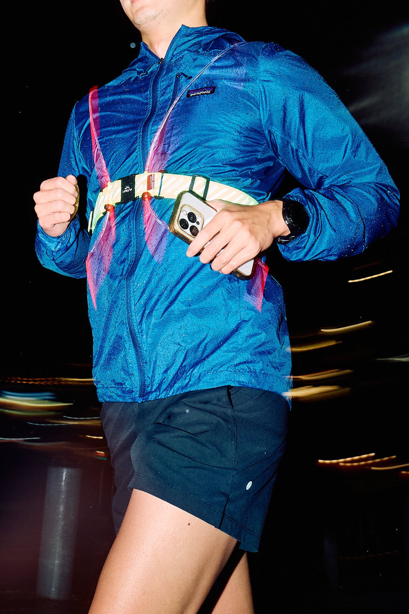 Runner moving through rain during a city training run.