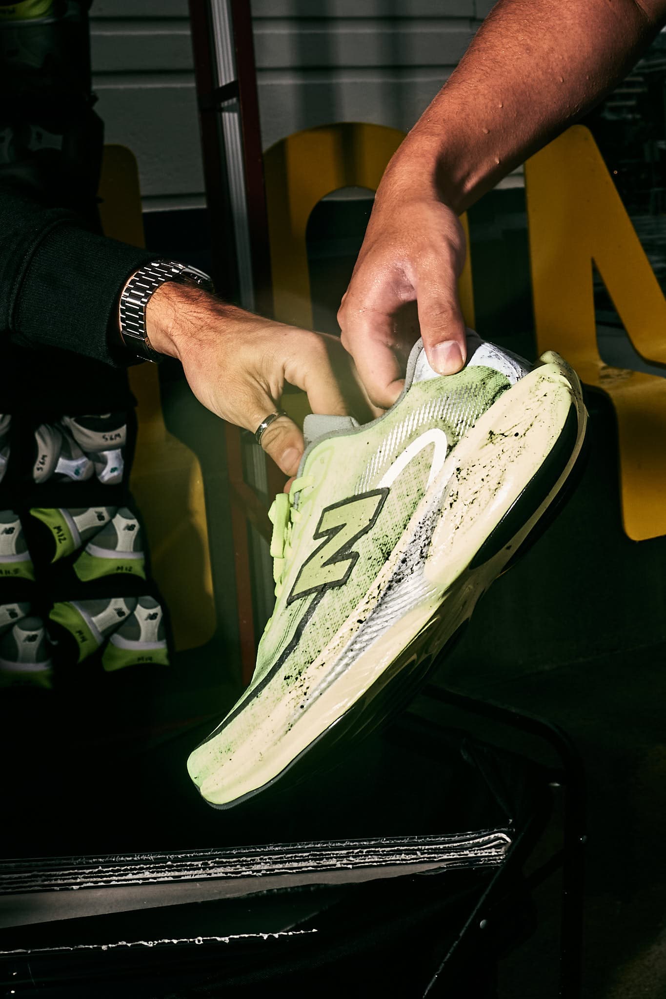 Close-up of New Balance running shoes on pavement.
