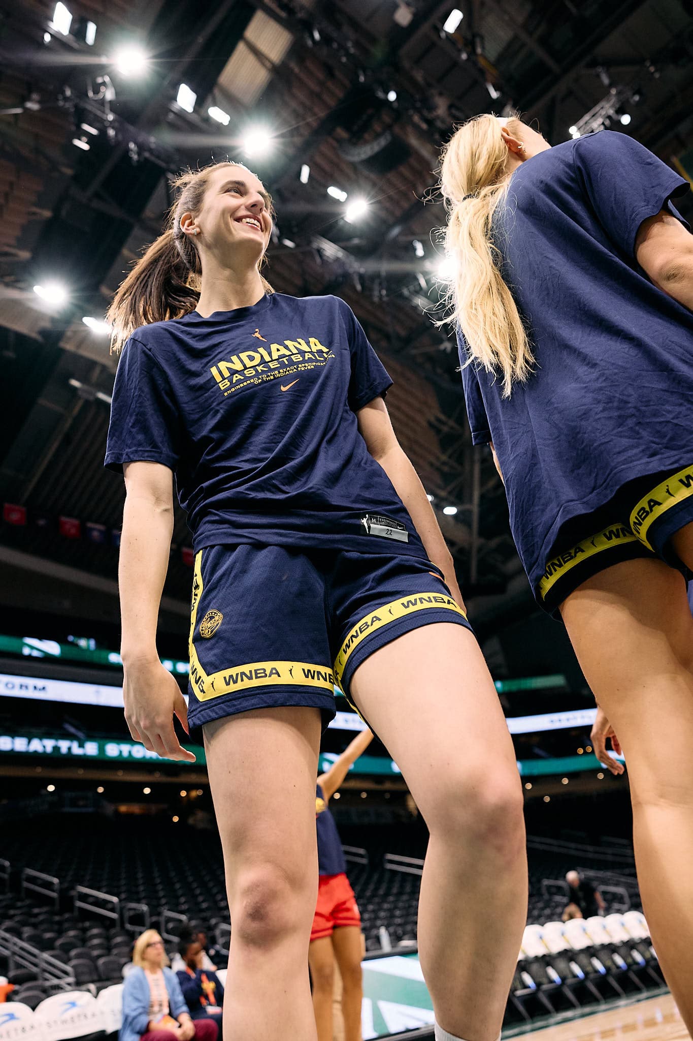 High-energy pre-game moment featuring Indiana WNBA players Caitlin Clark and Sophie Cunningham in dynamic motion during warm-ups — captured with sharp clarity and depth, ideal for showcasing elite sports photography and professional athleticism.
