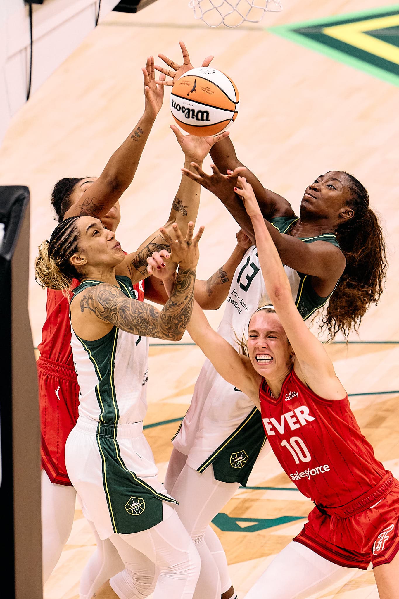Fierce WNBA action under the rim as players from opposing teams clash for a rebound — an electrifying moment that captures peak athletic intensity, split-second decision-making, and the raw power of women’s professional basketball. Ideal for showcasing elite sports photography talent