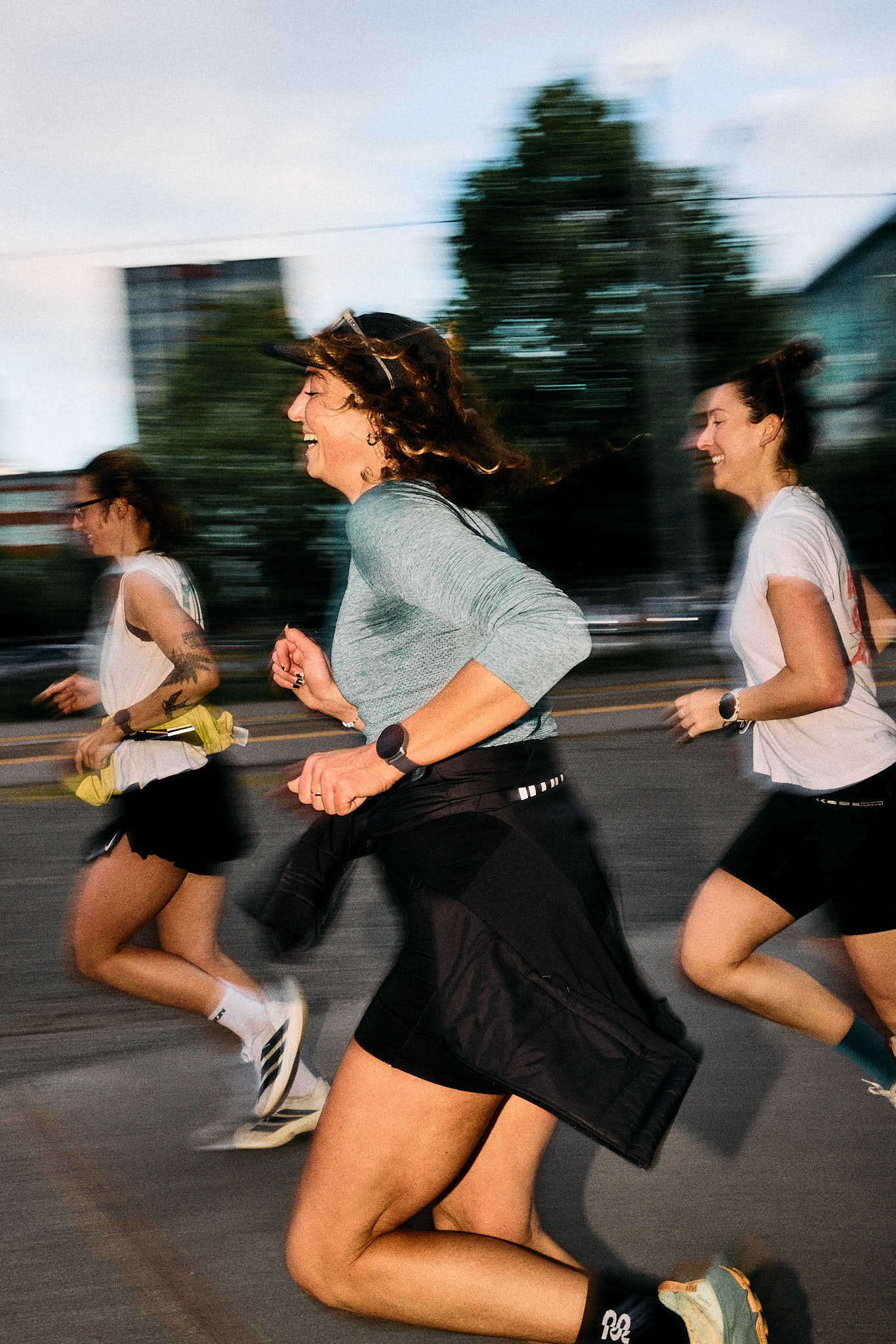 Editorial image of women runners training together outdoors.