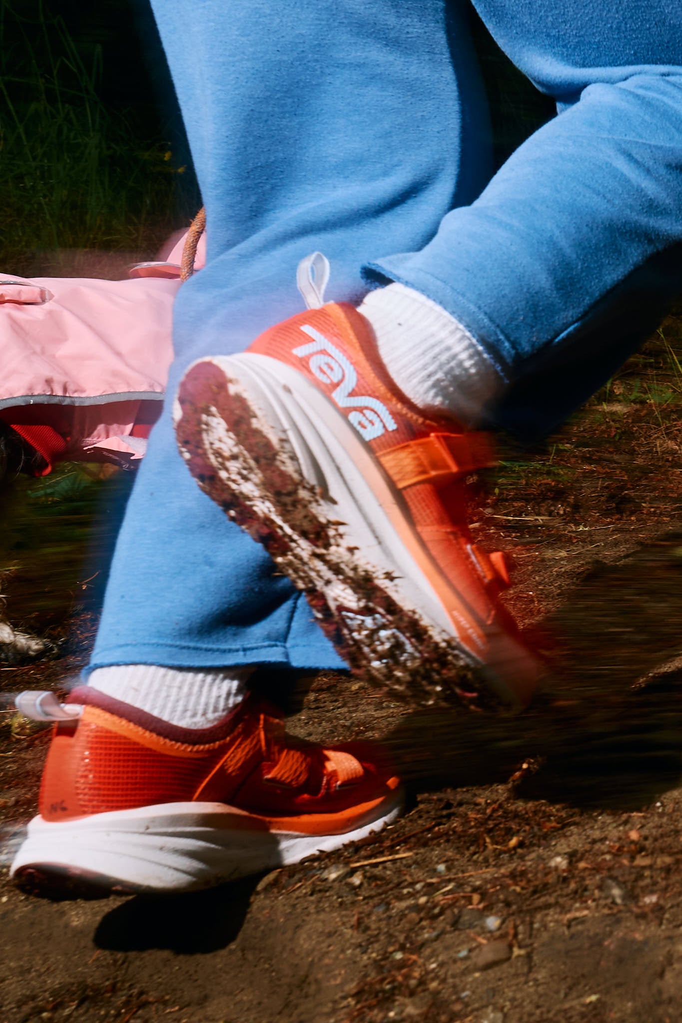 Close-up photo of Teva running footwear on the road.